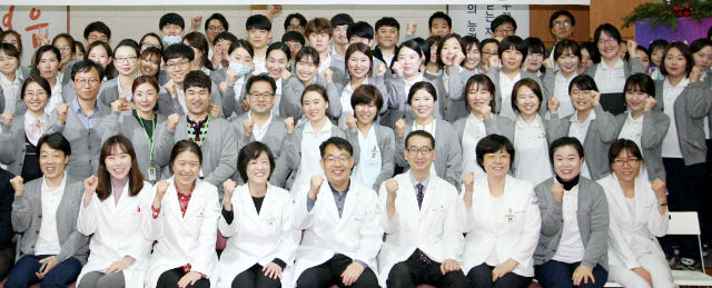 서울재활병원 윤한기념관에서 이지선 병원장(첫째줄 왼쪽에서 4번째)을 비롯한 직원들이 파이팅을 외치며 기념사진촬영을 하고 있다
