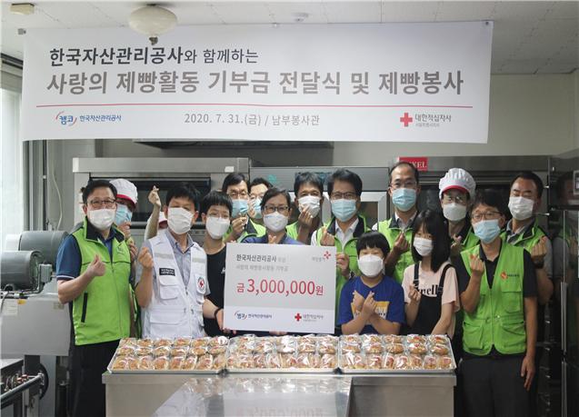 사랑의 빵 나누기 봉사활동에 참여한 한국자산관리공사 임직원들이 기념 촬영하고 있다