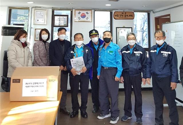 김성칠 서울중부모범운전자지회장(왼쪽 4번째)에게 마스크를 전달 후 관계자들이 기념 촬영에 임했다